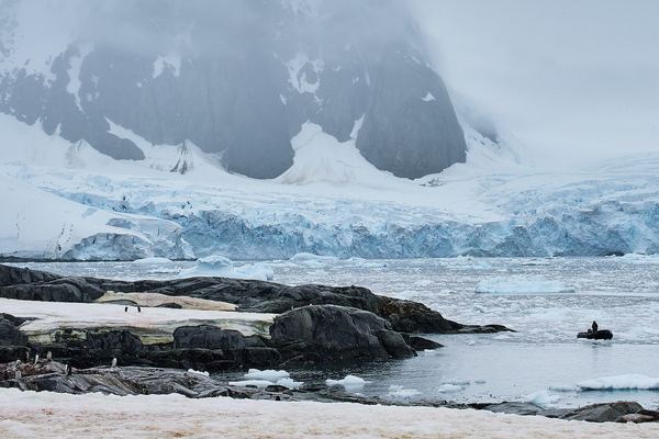 Snow-covered Antarctic landscape with ice and open water